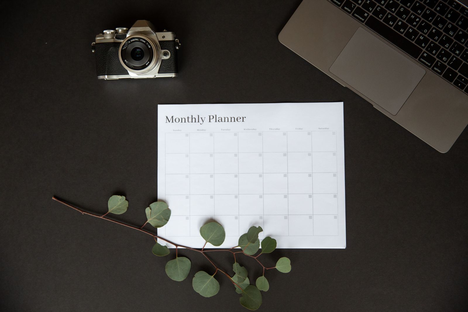 Blank monthly planner on a dark desk, for mapping MCC requirements
